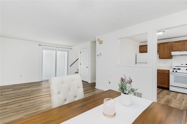 dining space featuring wood-type flooring