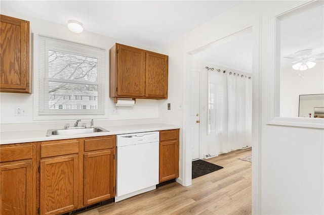 kitchen featuring white dishwasher, ceiling fan, sink, and light hardwood / wood-style flooring