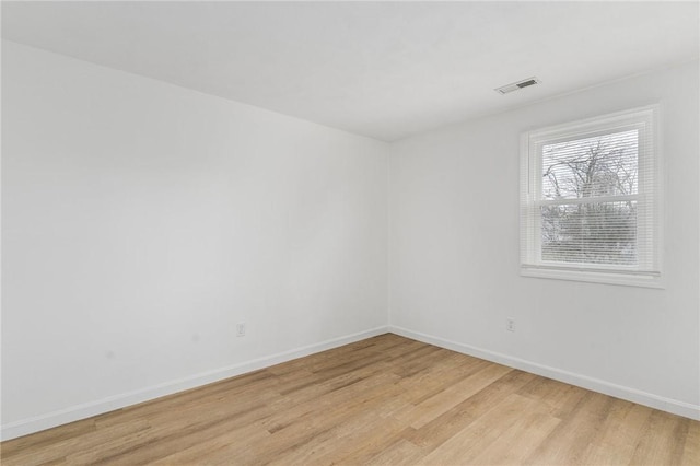 empty room with light hardwood / wood-style floors