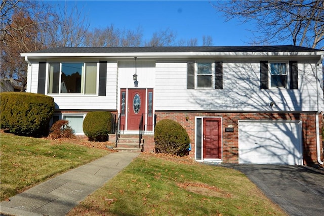 bi-level home featuring a garage and a front yard