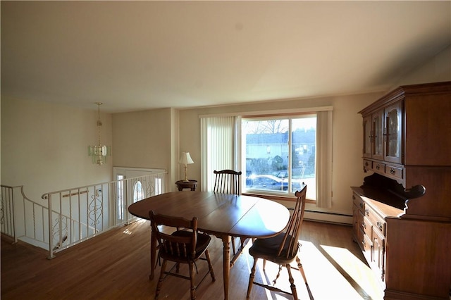 dining area with baseboard heating and wood-type flooring