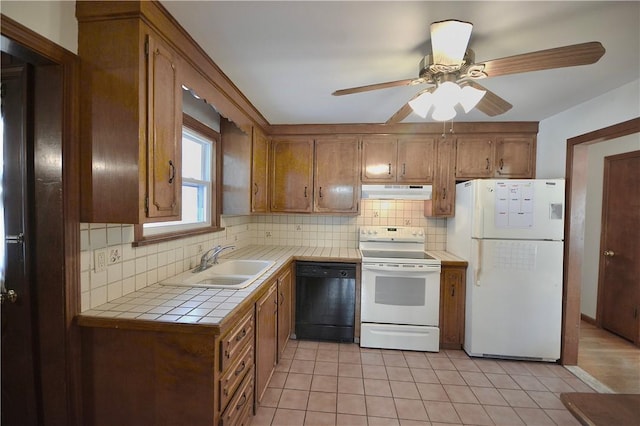 kitchen with white appliances, sink, ceiling fan, tasteful backsplash, and tile counters