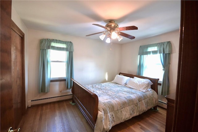 bedroom featuring baseboard heating, ceiling fan, and dark hardwood / wood-style flooring