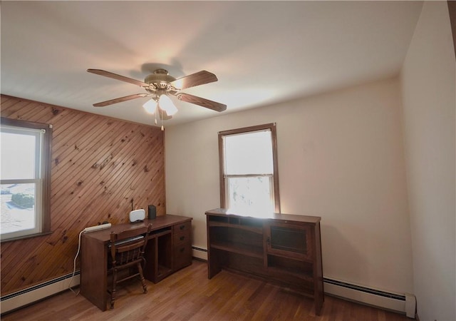 office area with hardwood / wood-style floors and a baseboard radiator