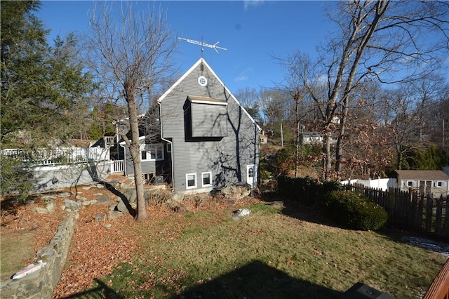 view of side of home with a yard