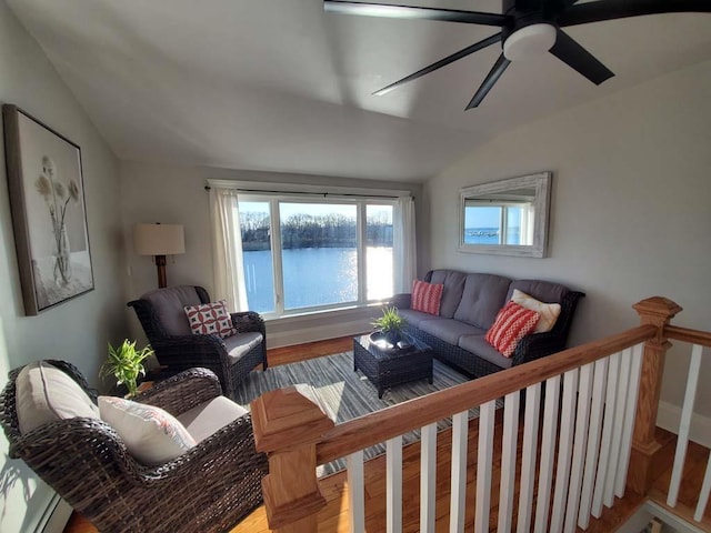 living room featuring a water view, wood-type flooring, and lofted ceiling