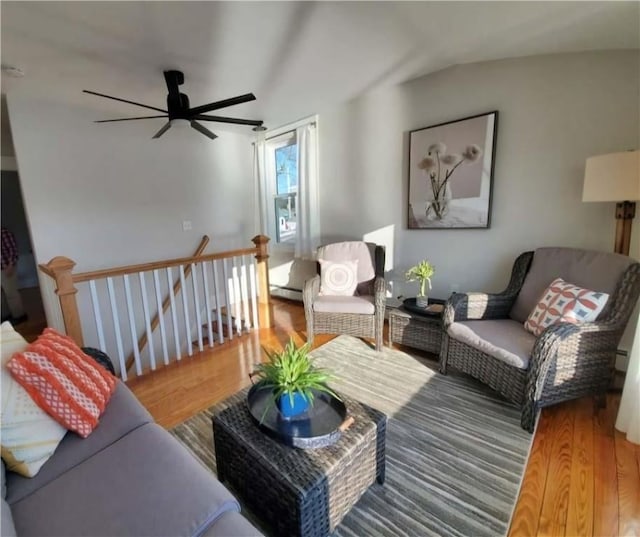 living room with lofted ceiling, ceiling fan, and wood-type flooring