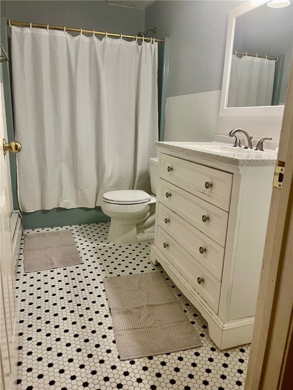 bathroom featuring tile patterned floors, vanity, toilet, and a shower with shower curtain