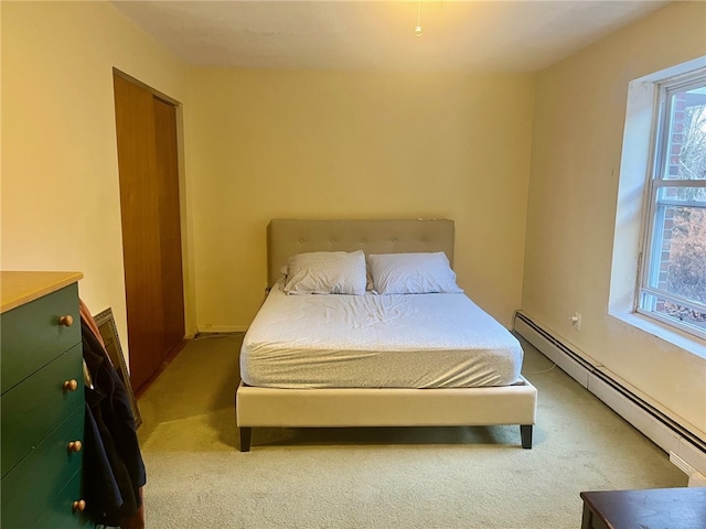 bedroom featuring carpet floors and a baseboard heating unit