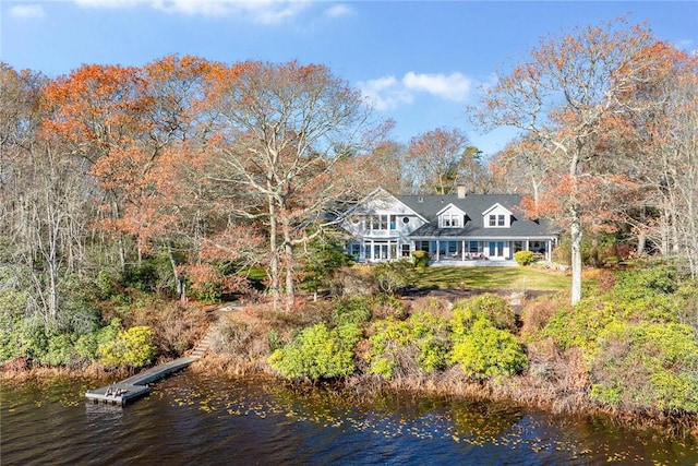 rear view of property with a water view