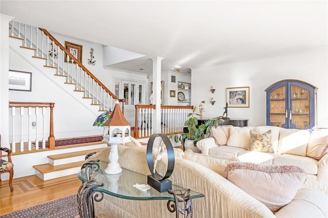 living room with hardwood / wood-style floors and ornate columns