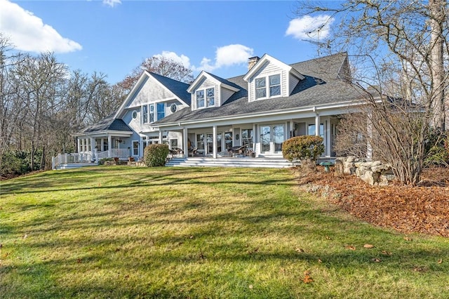 cape cod-style house with a front yard and a porch