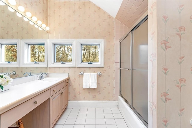 bathroom featuring tile patterned flooring, vanity, and bath / shower combo with glass door