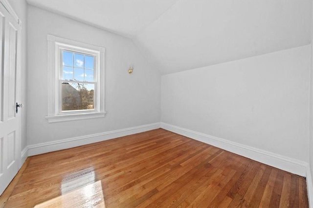 bonus room with light hardwood / wood-style floors and lofted ceiling