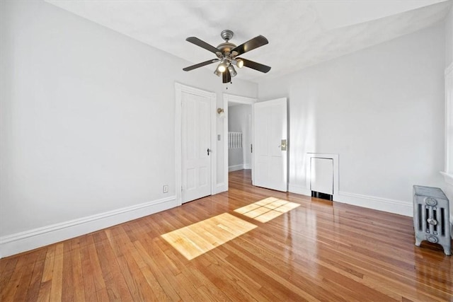 spare room featuring hardwood / wood-style floors and ceiling fan