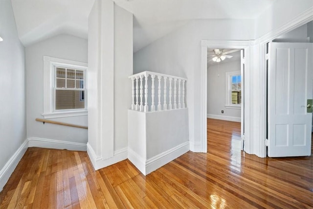 unfurnished bedroom with hardwood / wood-style floors and vaulted ceiling