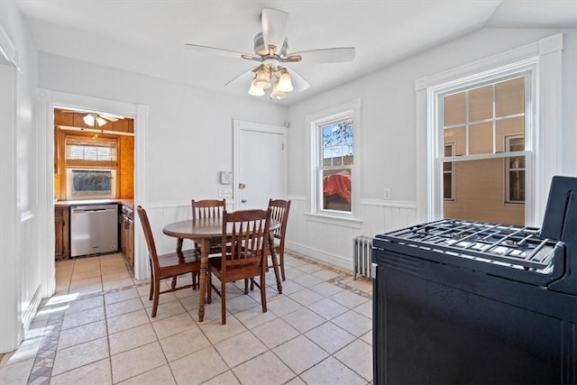 dining area featuring radiator, ceiling fan, and light tile patterned floors