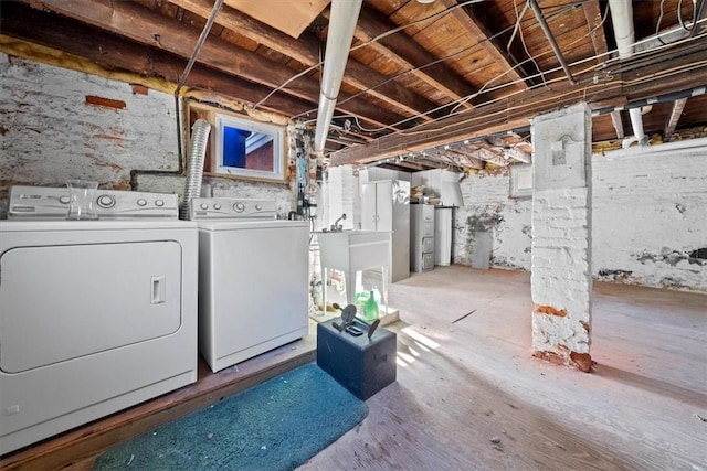 basement with washing machine and dryer, sink, and water heater