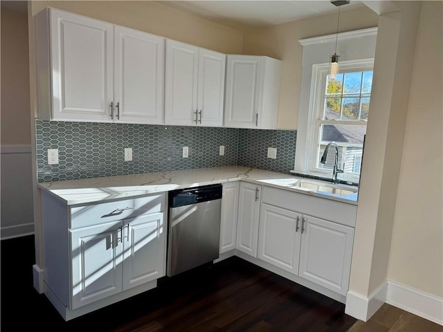 kitchen with dishwasher, sink, dark hardwood / wood-style floors, pendant lighting, and white cabinets