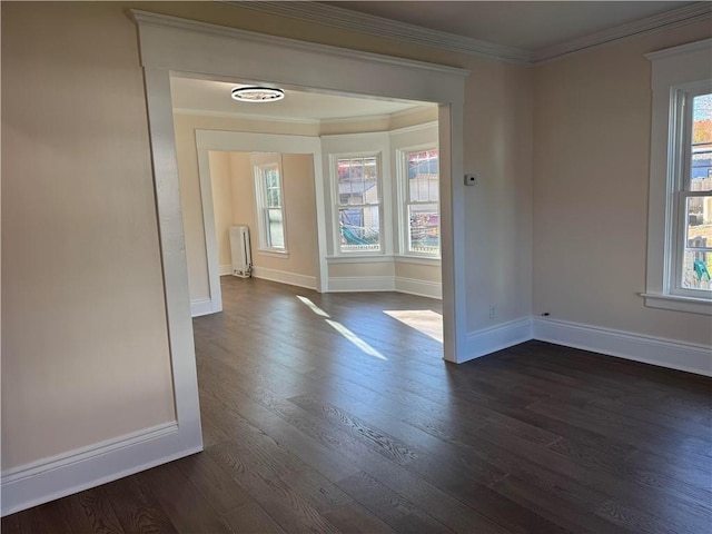 unfurnished room with dark hardwood / wood-style flooring and crown molding