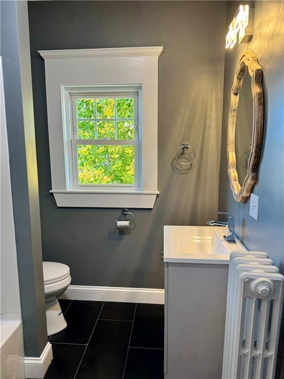 bathroom with tile patterned flooring, vanity, toilet, and radiator