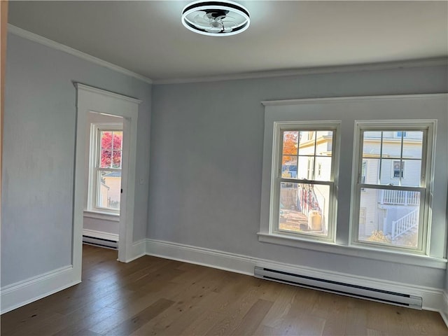 empty room featuring baseboard heating, crown molding, and dark hardwood / wood-style floors