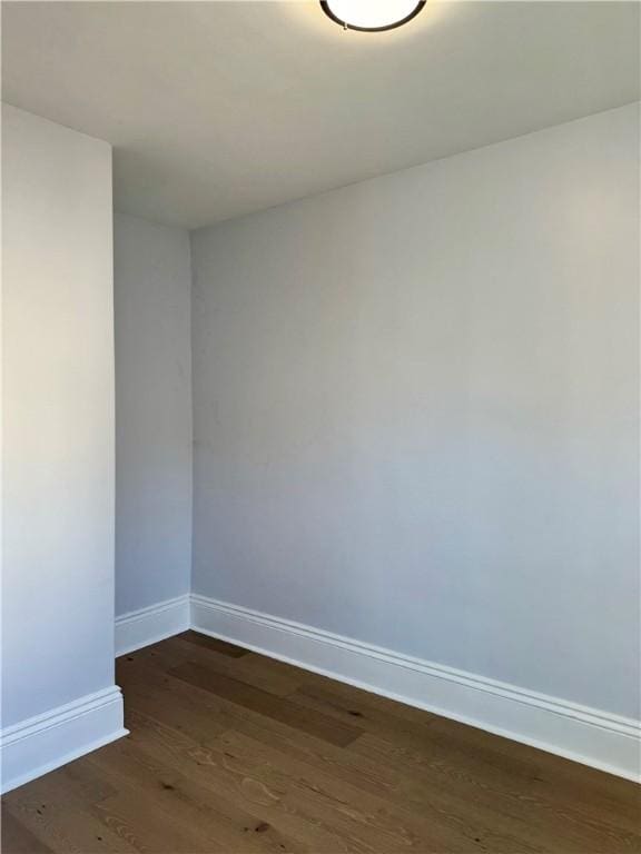 unfurnished room featuring dark hardwood / wood-style flooring