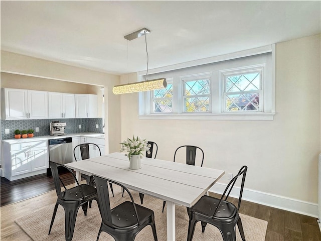 dining area with dark hardwood / wood-style floors