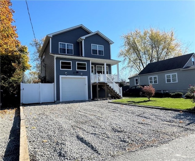 view of property with a garage, a porch, and a front yard