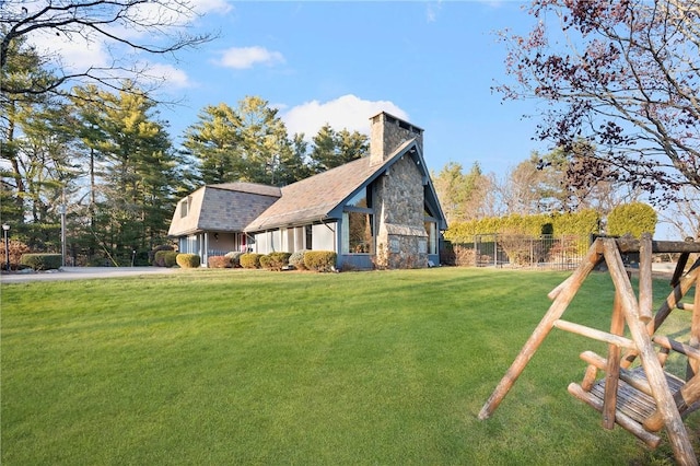 view of side of home with a yard