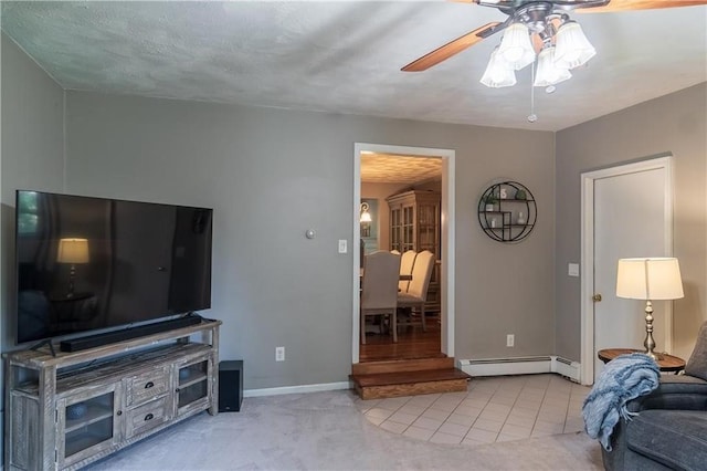 living room with ceiling fan, light colored carpet, a baseboard radiator, and a textured ceiling