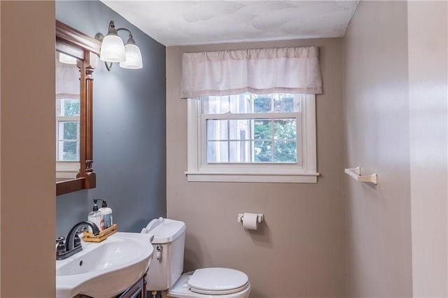 bathroom featuring plenty of natural light, vanity, and toilet