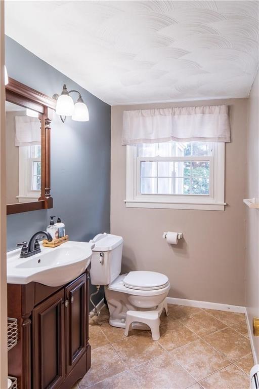 bathroom featuring tile patterned floors, vanity, and toilet