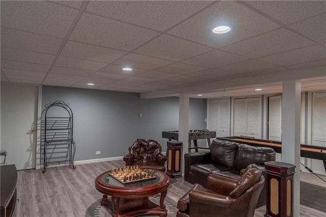 living room featuring hardwood / wood-style flooring and a drop ceiling