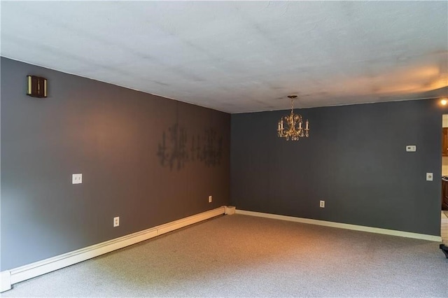 unfurnished room featuring baseboard heating, carpet, and a chandelier