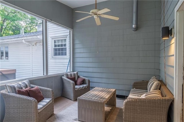 sunroom featuring ceiling fan