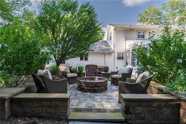 view of patio / terrace with an outdoor living space with a fire pit