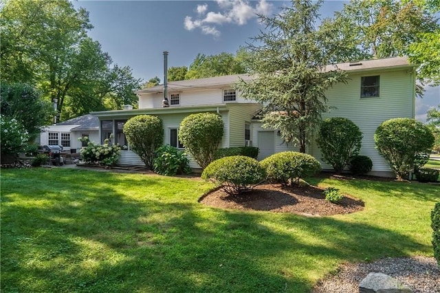 rear view of property featuring a lawn