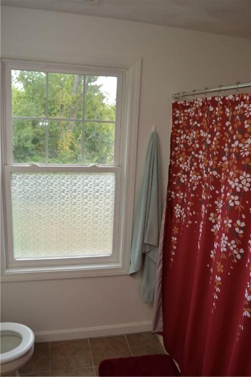 bathroom featuring toilet and tile patterned floors