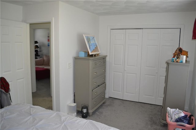 carpeted bedroom with a closet