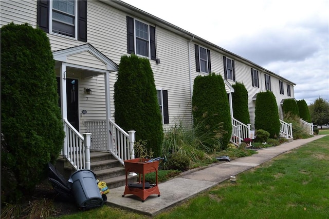 view of side of home featuring a yard