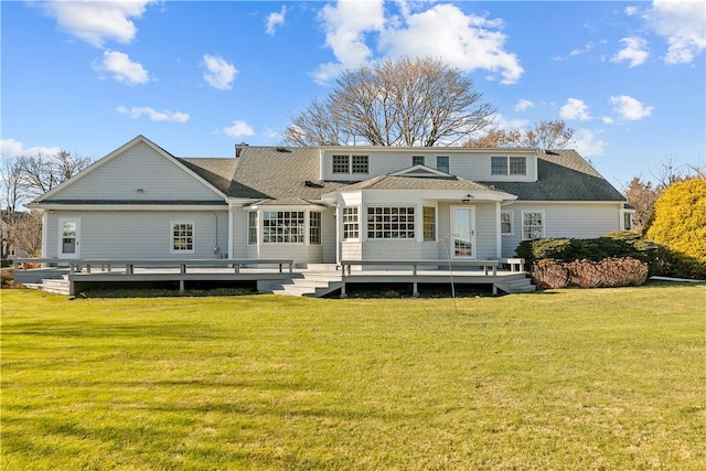 back of house with a lawn and a deck