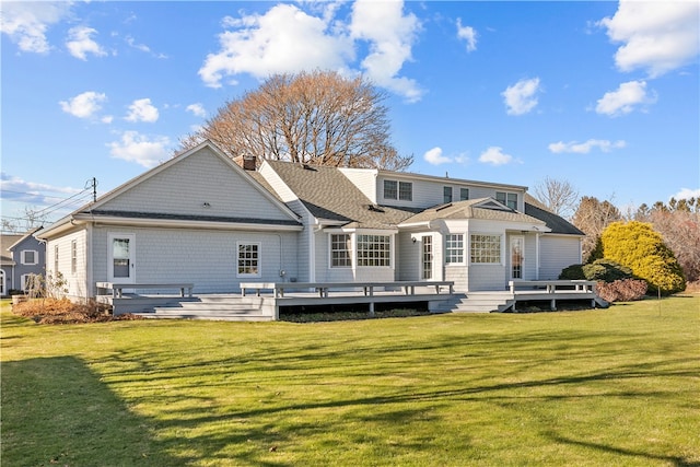 back of house featuring a deck and a yard