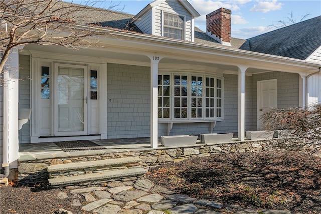 view of exterior entry with covered porch