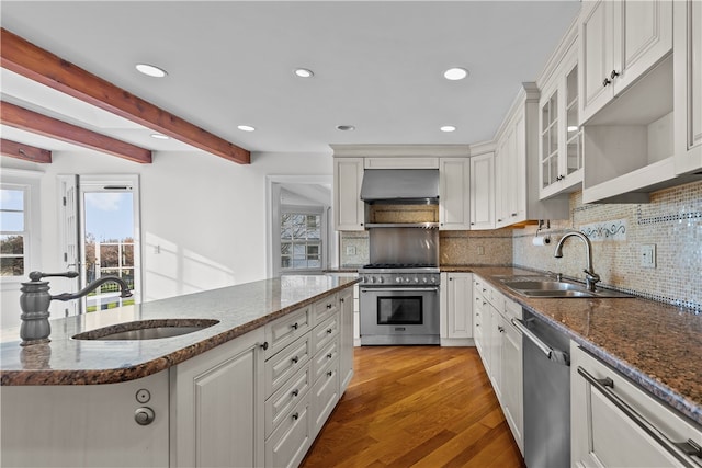 kitchen with ventilation hood, white cabinets, sink, and stainless steel appliances