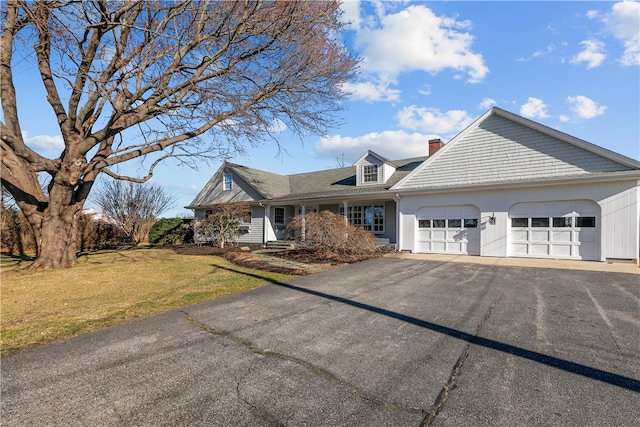 view of front of home featuring a garage and a front lawn