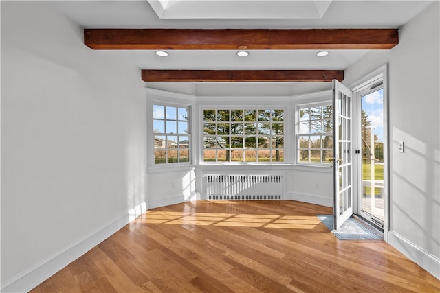 interior space with radiator heating unit and beamed ceiling