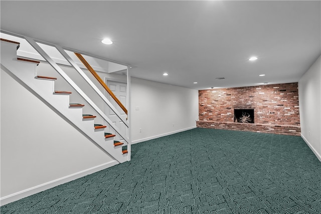 basement with a fireplace, carpet floors, and brick wall