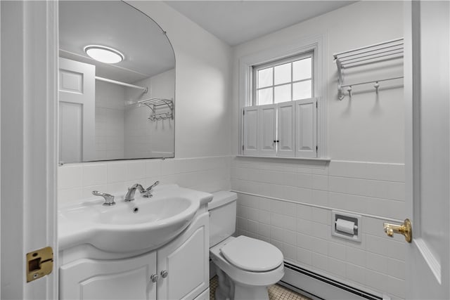 bathroom featuring vanity, a baseboard heating unit, tile walls, tile patterned flooring, and toilet