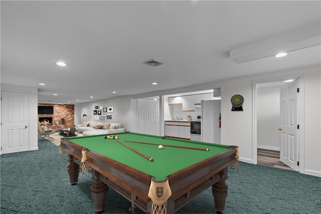 rec room featuring dark colored carpet, a fireplace, and billiards